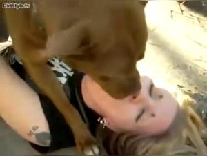 woman kisses dog